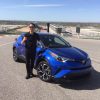 Hiroyuki Koba standing next to his prodigy, the 2018 Toyota C-HR, on a visit to Turn 1 at the Circuit of the Americas racetrack in Austin, Texas.